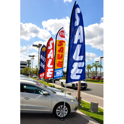 Promotional swooper flags displayed on a dealership lot